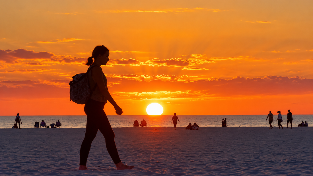 Marco Island beach sunset with silhouetted walker at golden hour