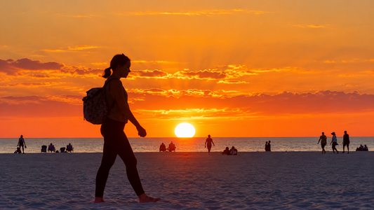 Marco Island beach sunset with silhouetted walker at golden hour